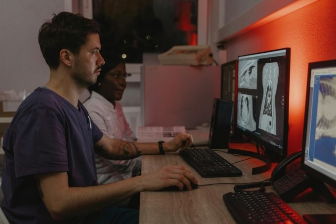 pet scan image of doctor looking at screen