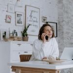 Self-employed person reviewing private health insurance documents in home office
