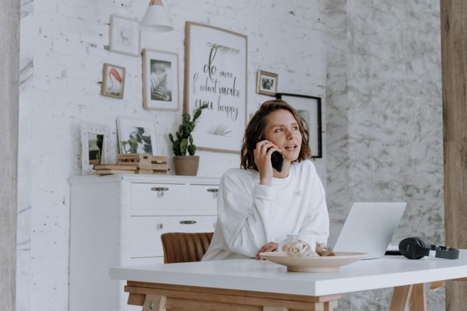 Self-employed person reviewing private health insurance documents in home office